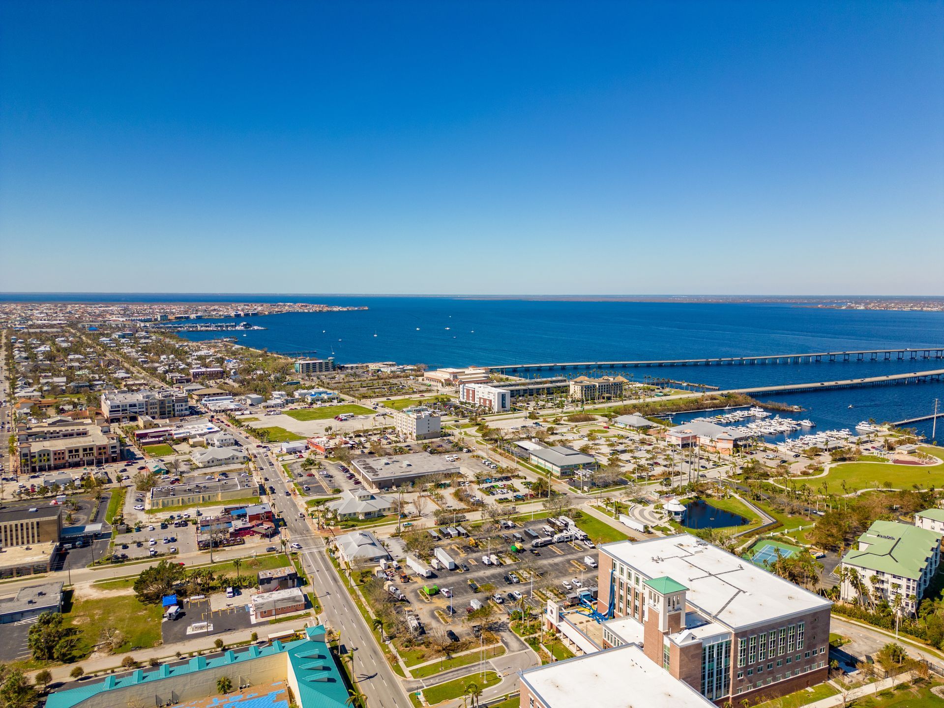 An aerial view of a city with a large body of water in the background.