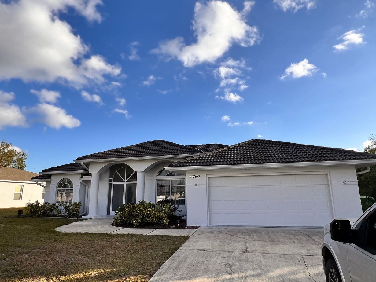 A house with a car parked in front of it.
