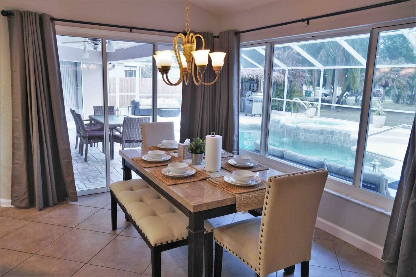 A dining room with a table and chairs and a chandelier.