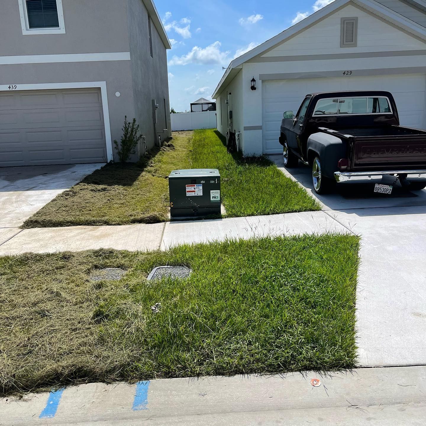 A brown truck is parked in front of a house