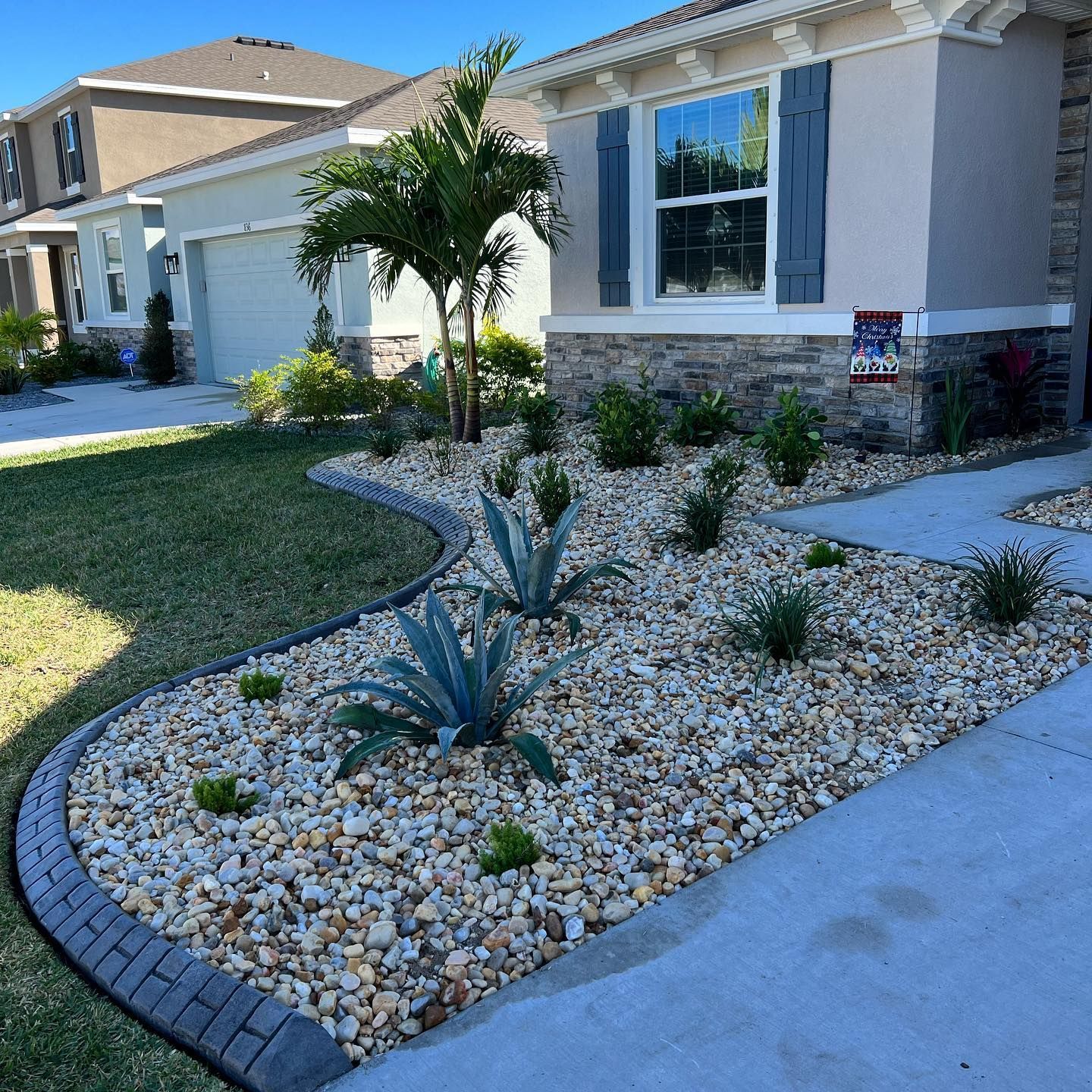 A house with a gravel garden in front of it