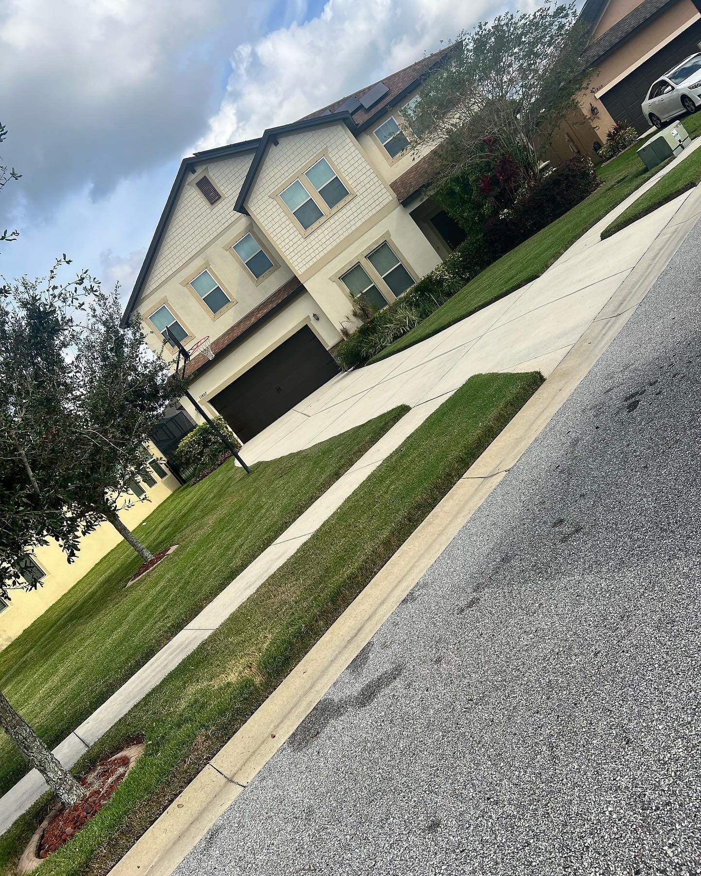 A large house with a car parked in front of it