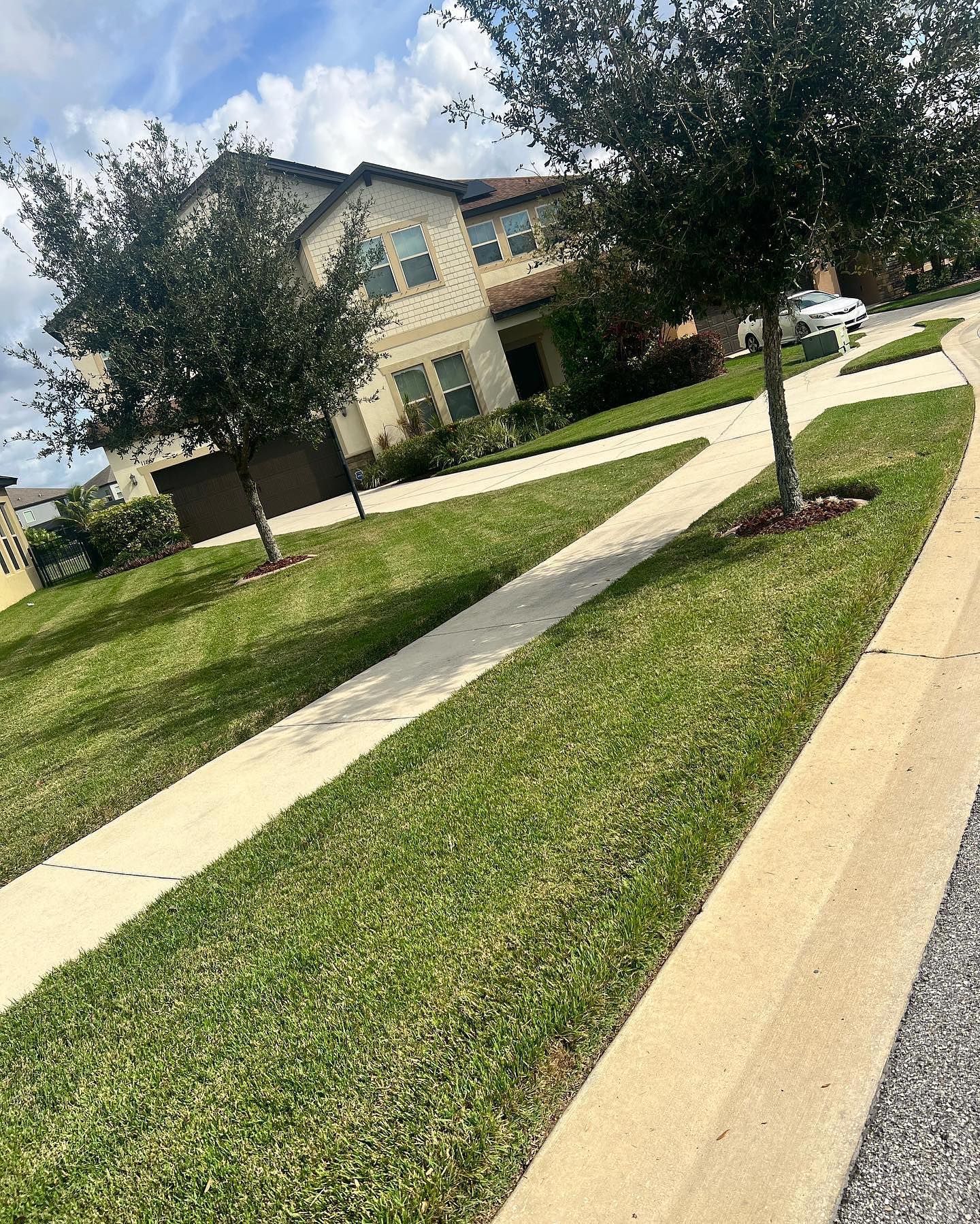 A row of sidewalks leading to a house in a residential neighborhood.