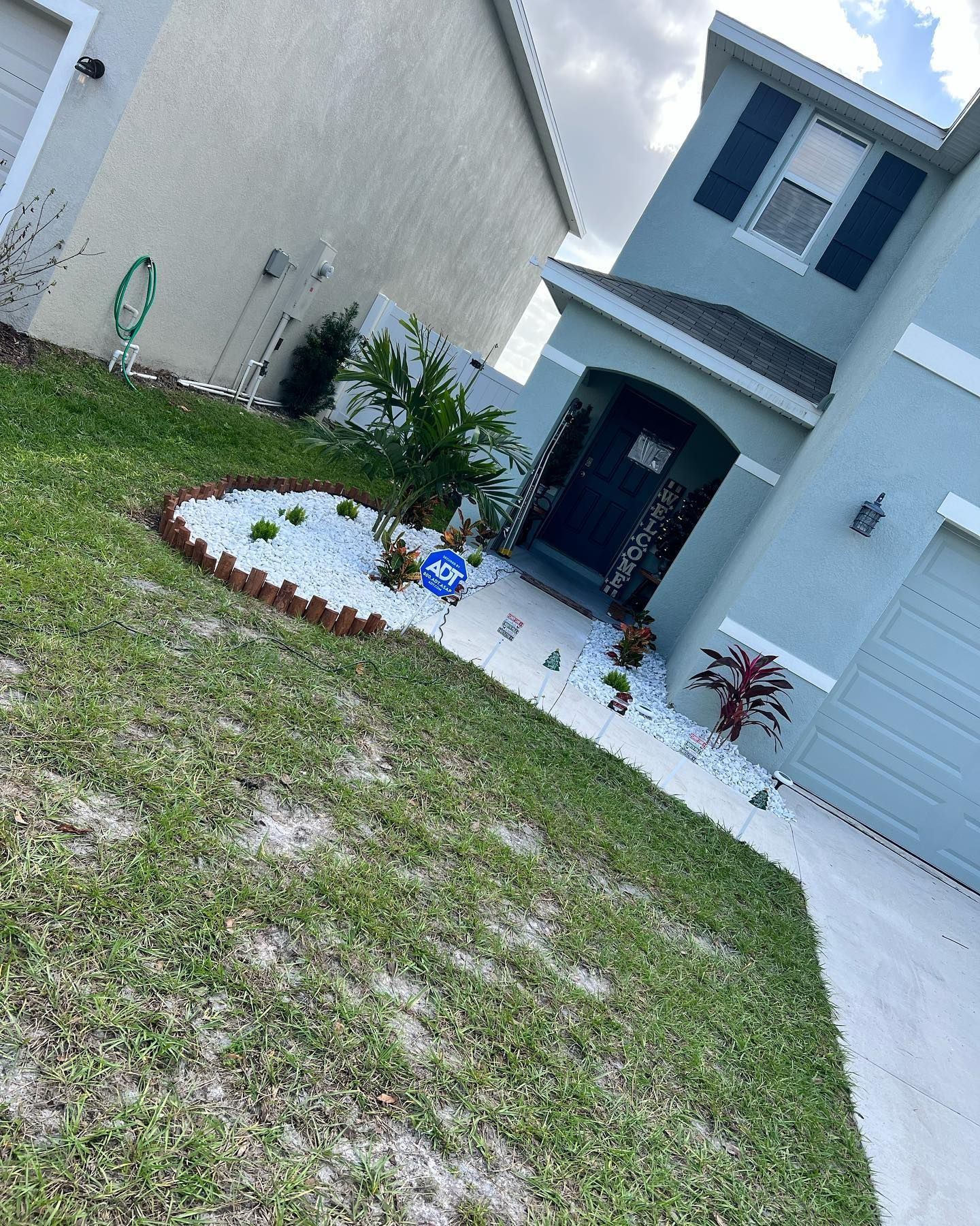 A house with a lush green lawn in front of it.
