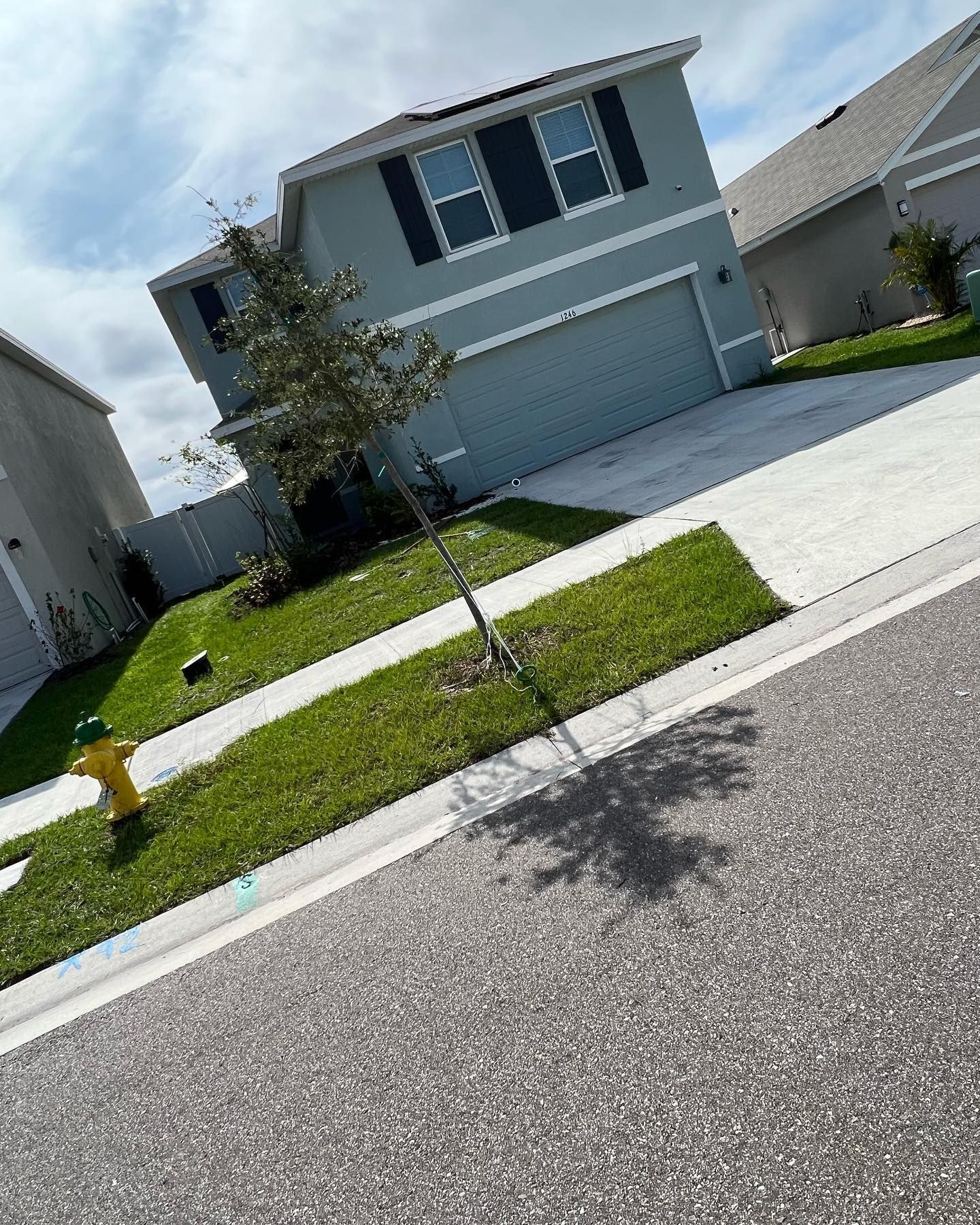 A house with a fire hydrant in front of it in a residential neighborhood.