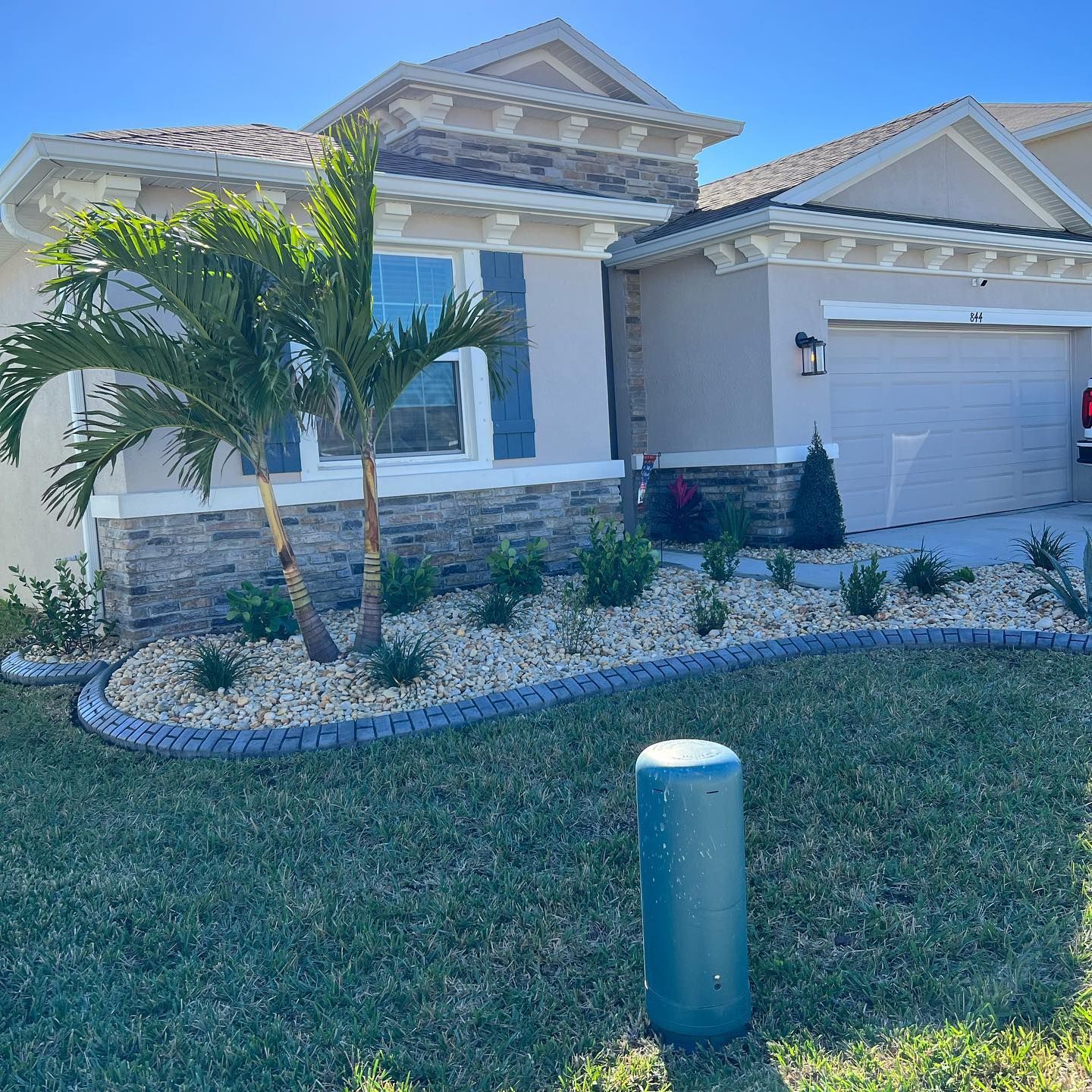 A house with a lot of plants in front of it