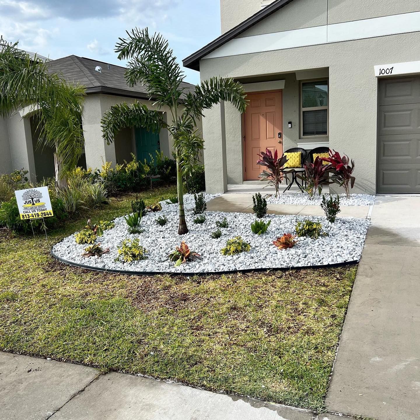 A house with a lot of plants in front of it