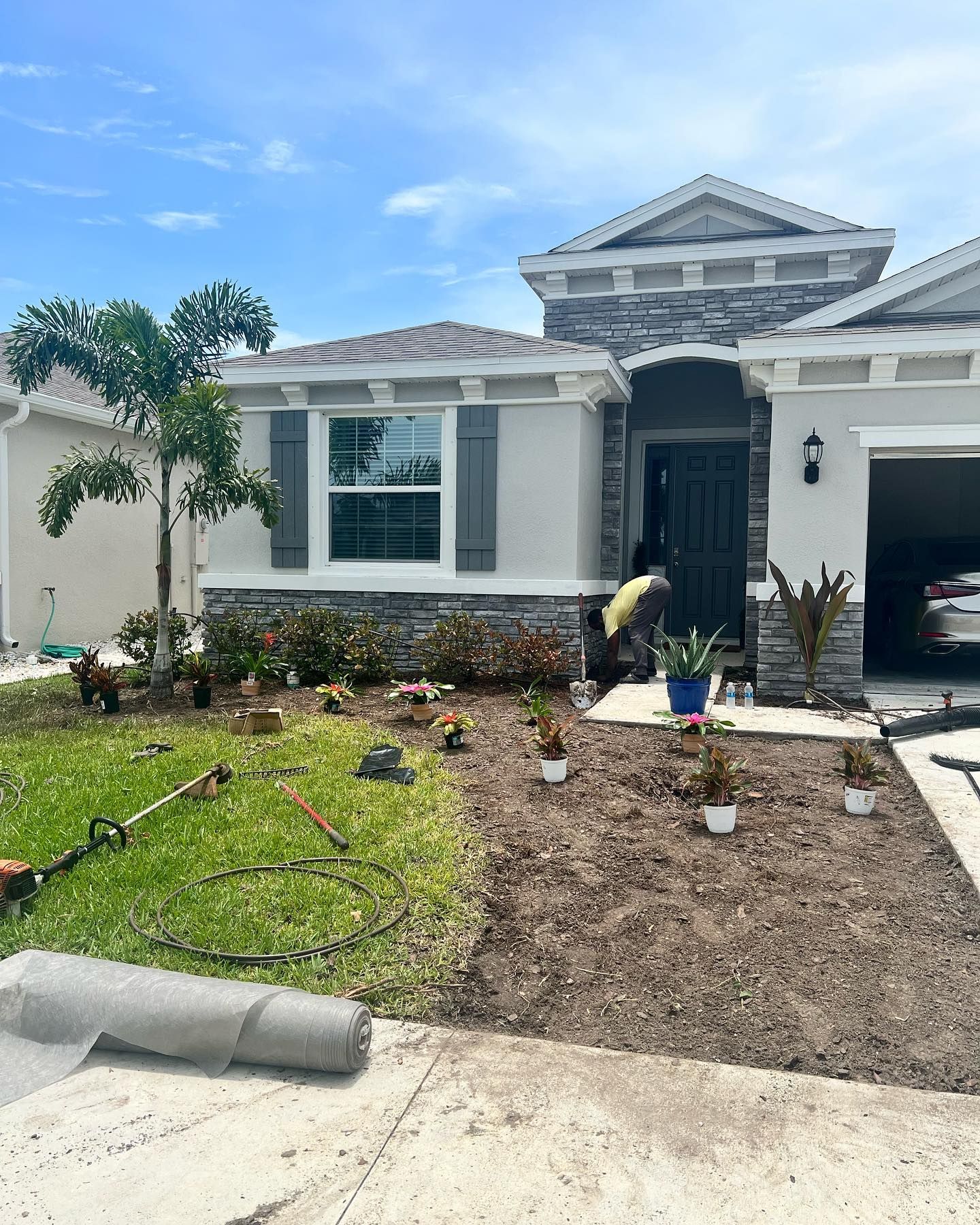 A man is working on the front of a house.