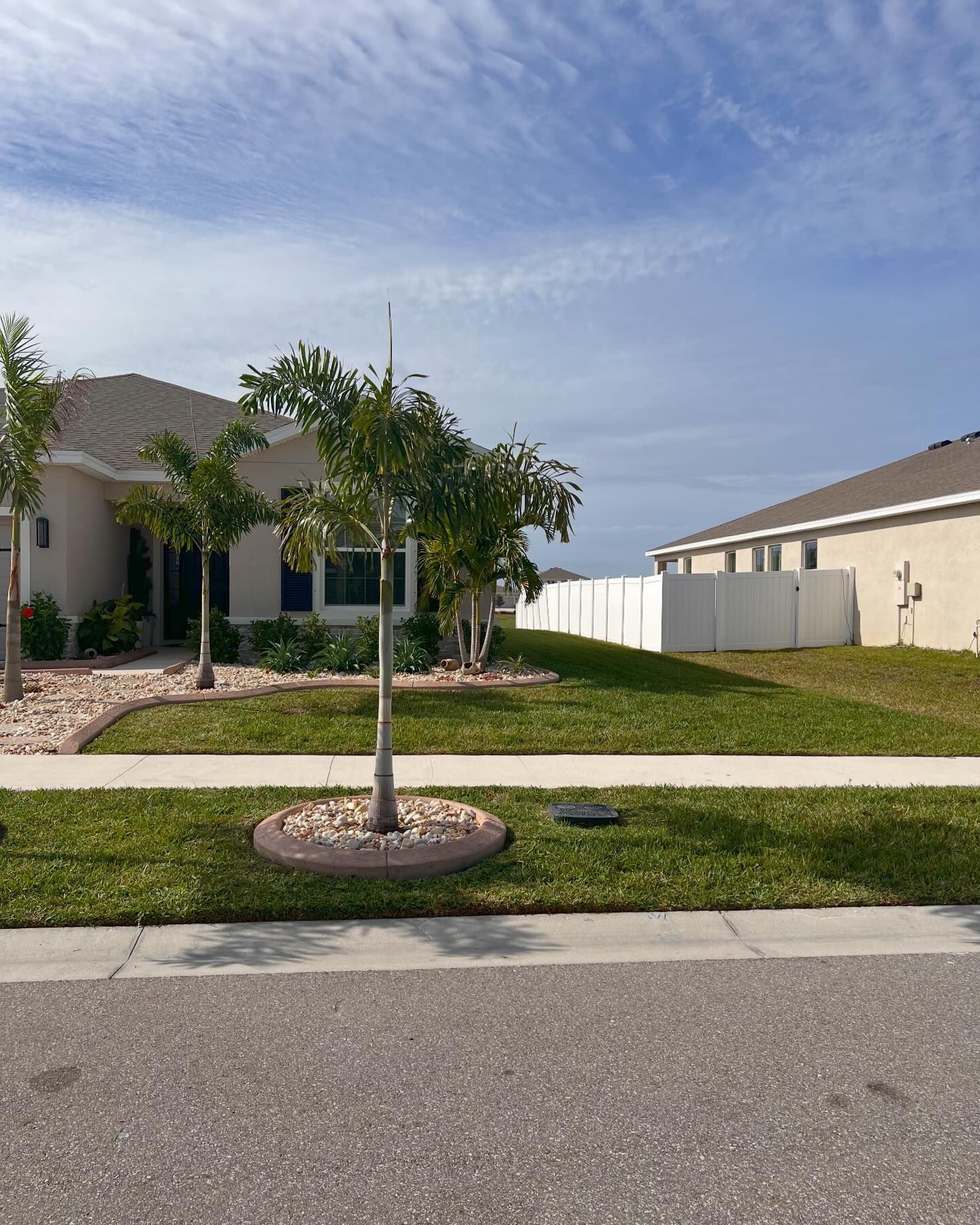 A house with a lot of grass and trees in front of it
