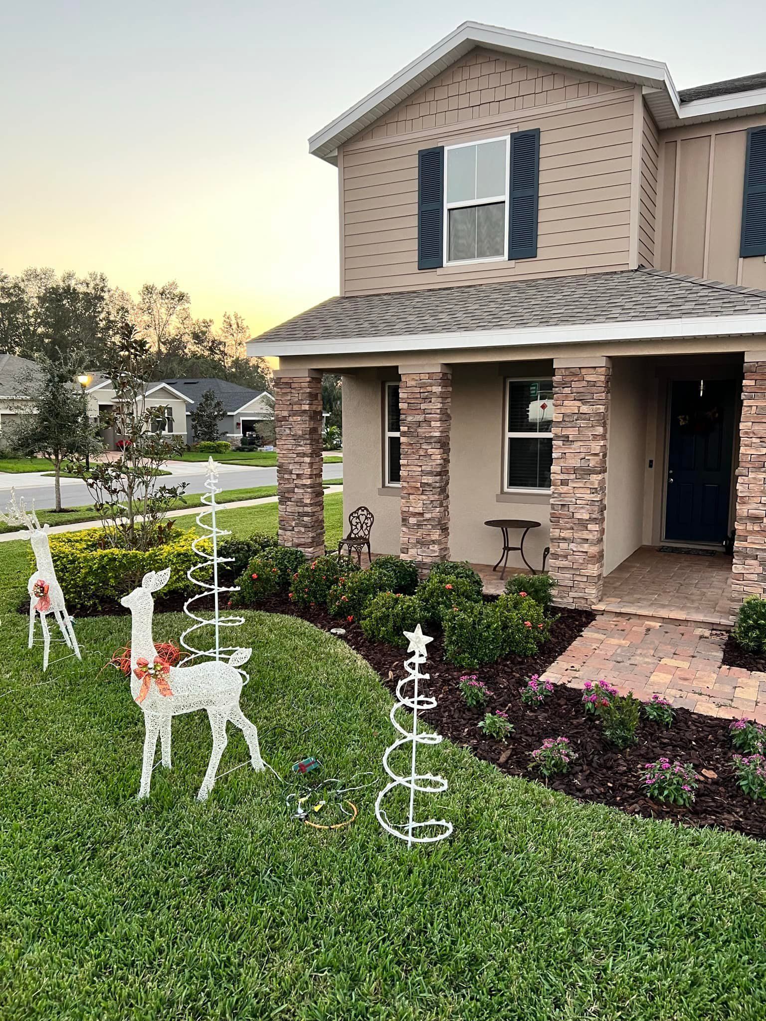 A house with a christmas decoration in front of it.