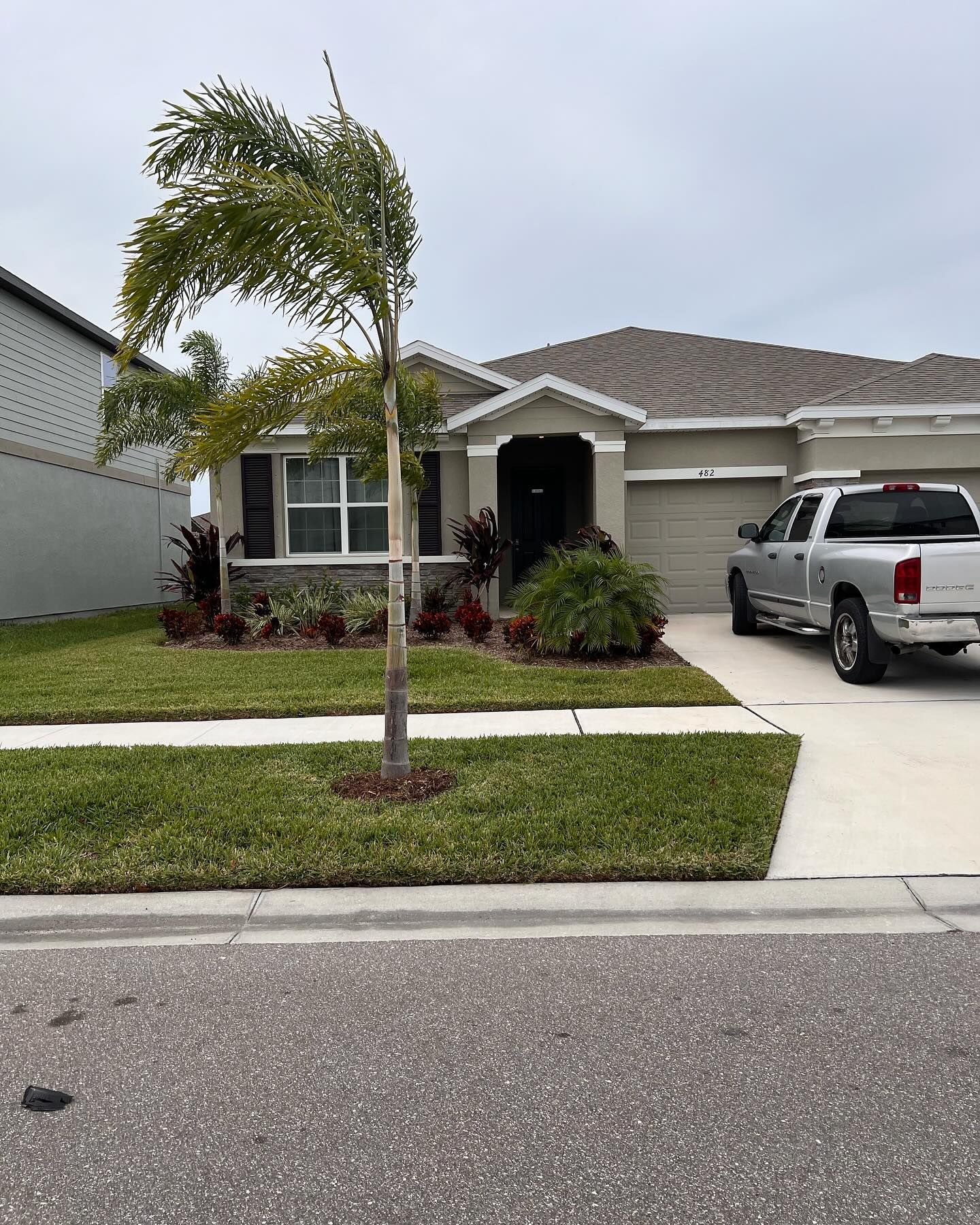 A house with a truck parked in front of it