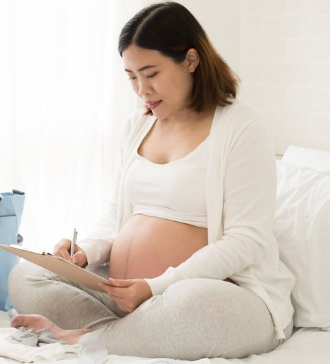 Prenatal Care — Pregnant Woman In The Bed in Fresno, CA