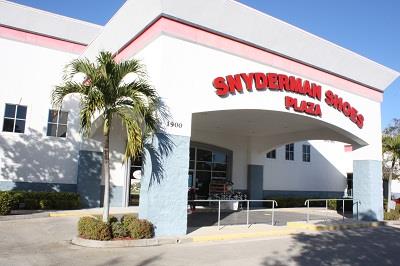 A skyberman shoes store with a palm tree in front of it