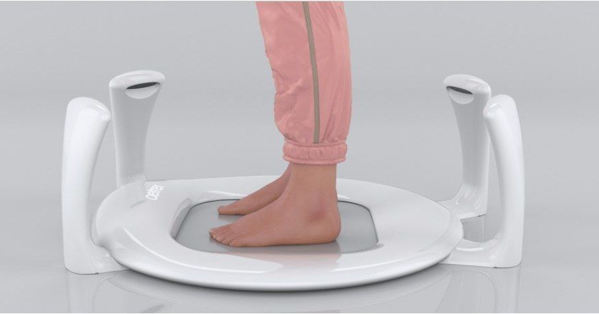 A person is standing on a scale with their feet on it.