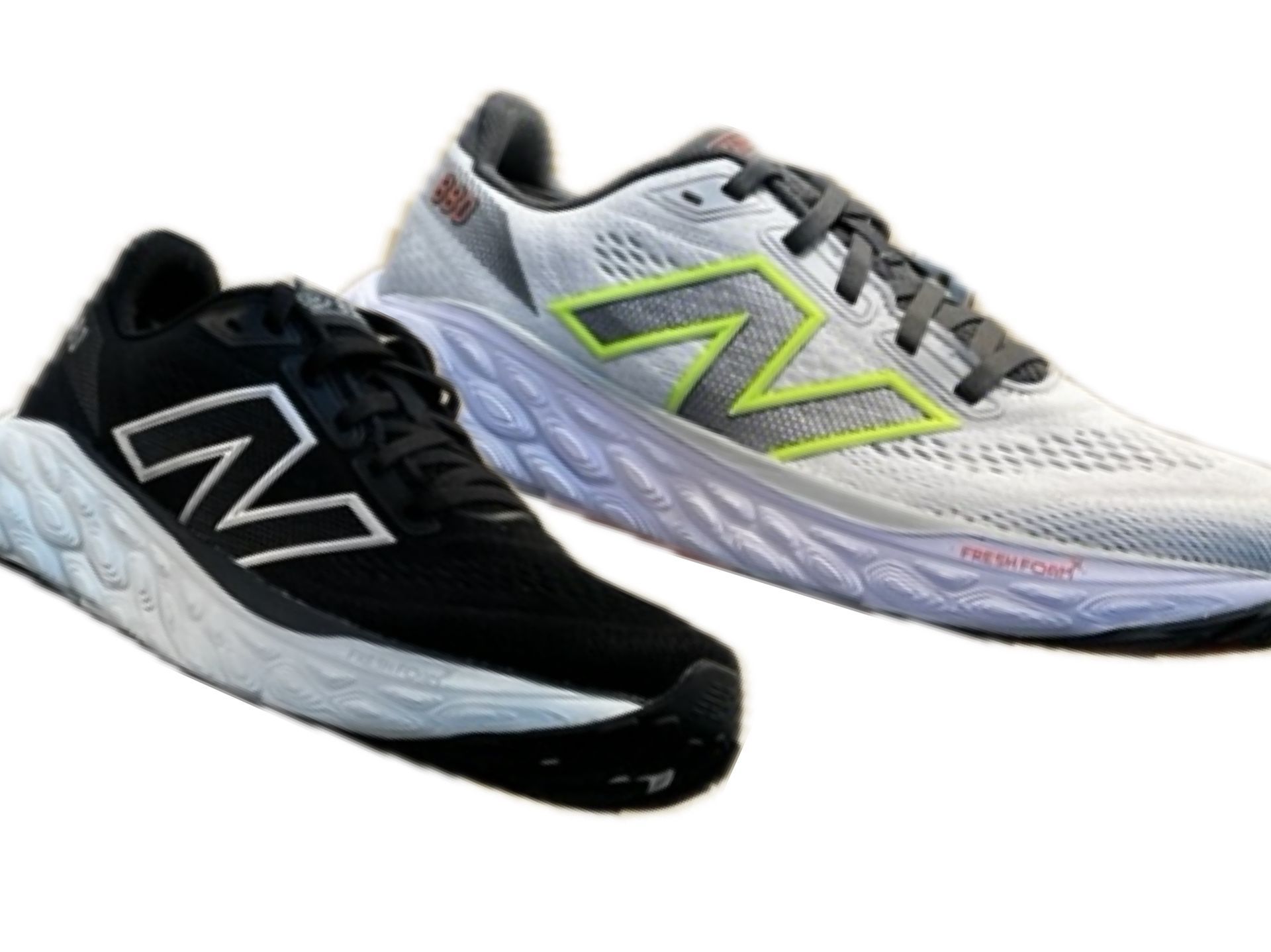 A pair of black and white new balance shoes on a white background