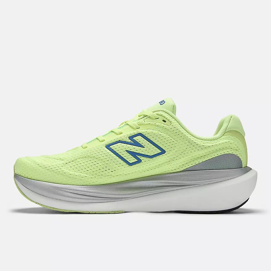 A pair of new balance shoes are sitting on the floor.