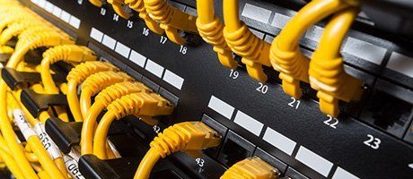 Close-up view on a patch panel with yellow network cables