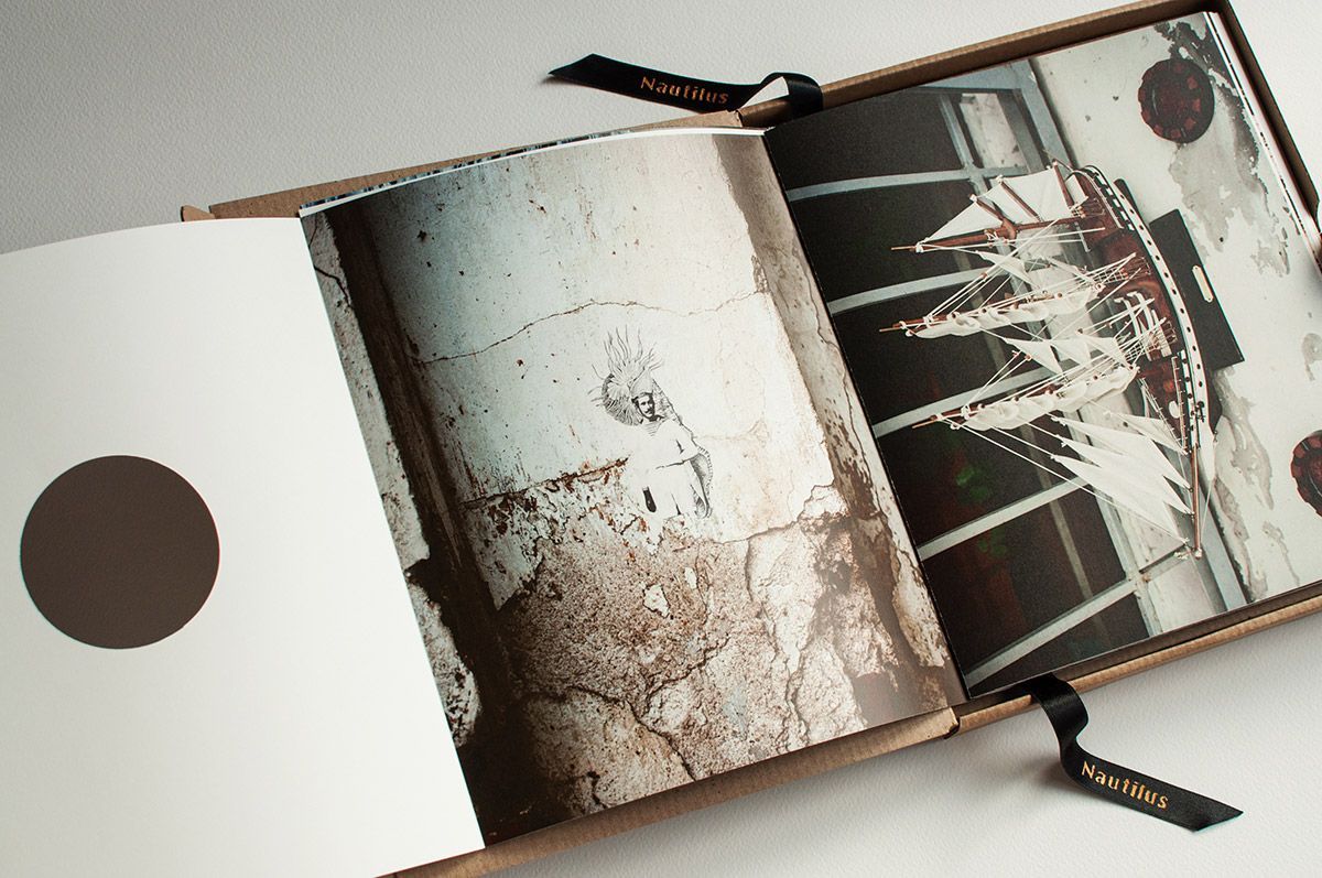 Open book with a brown circle on the left page, column close-up on the middle page, and a fragmented image on the right.