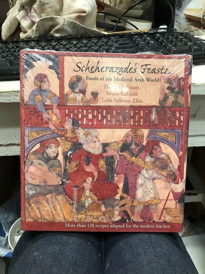 Box art for Scheherazade's Feasts board game, depicting a colorful Middle Eastern feast scene.