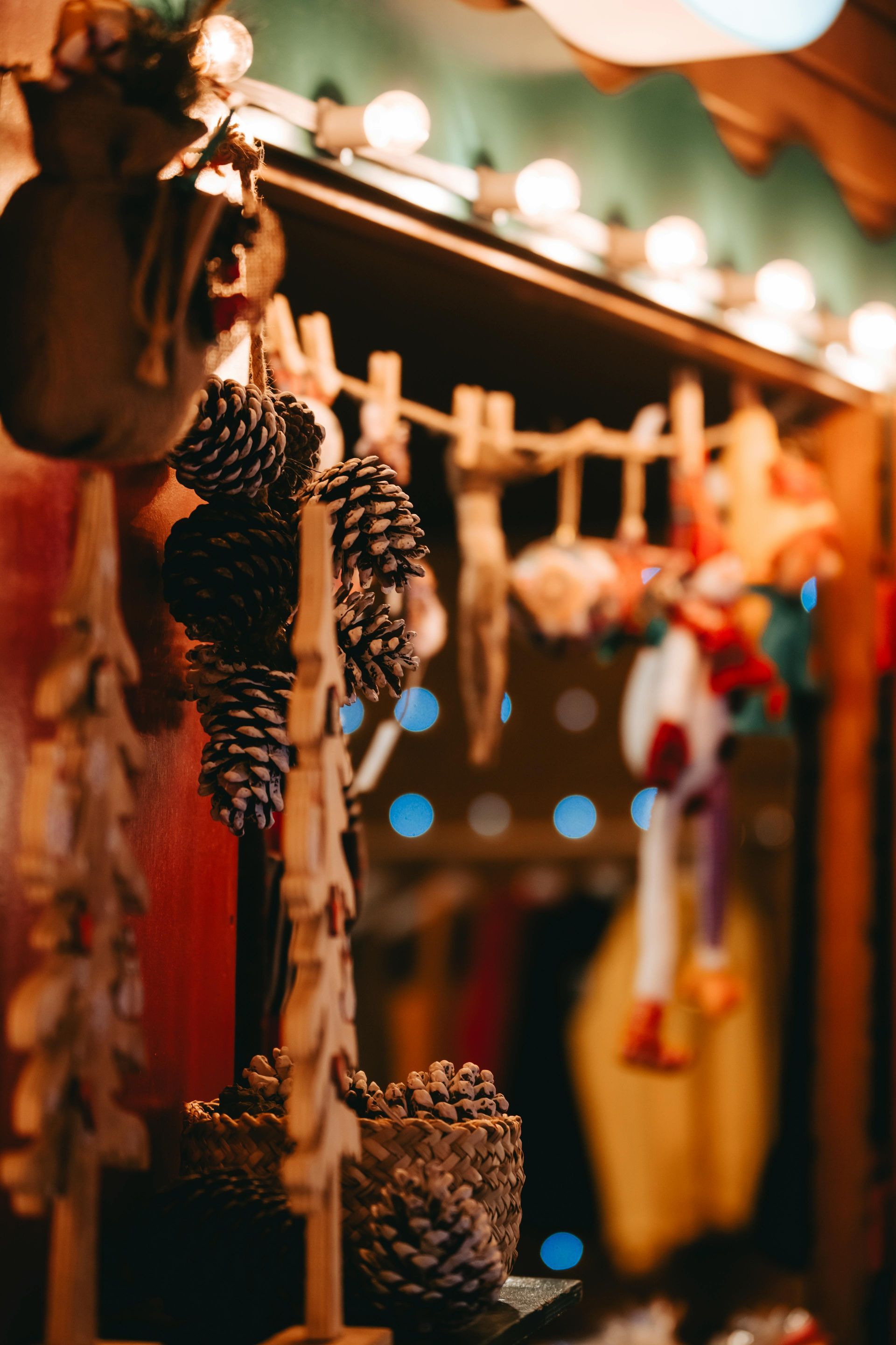 A bunch of pine cones hanging on a clothesline at a christmas market.