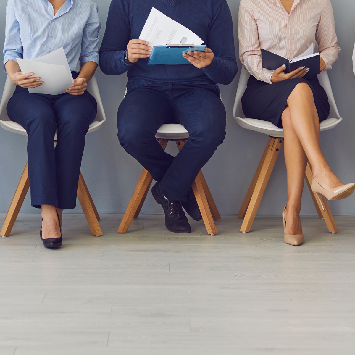 3 people sitting waiting to be interviewed