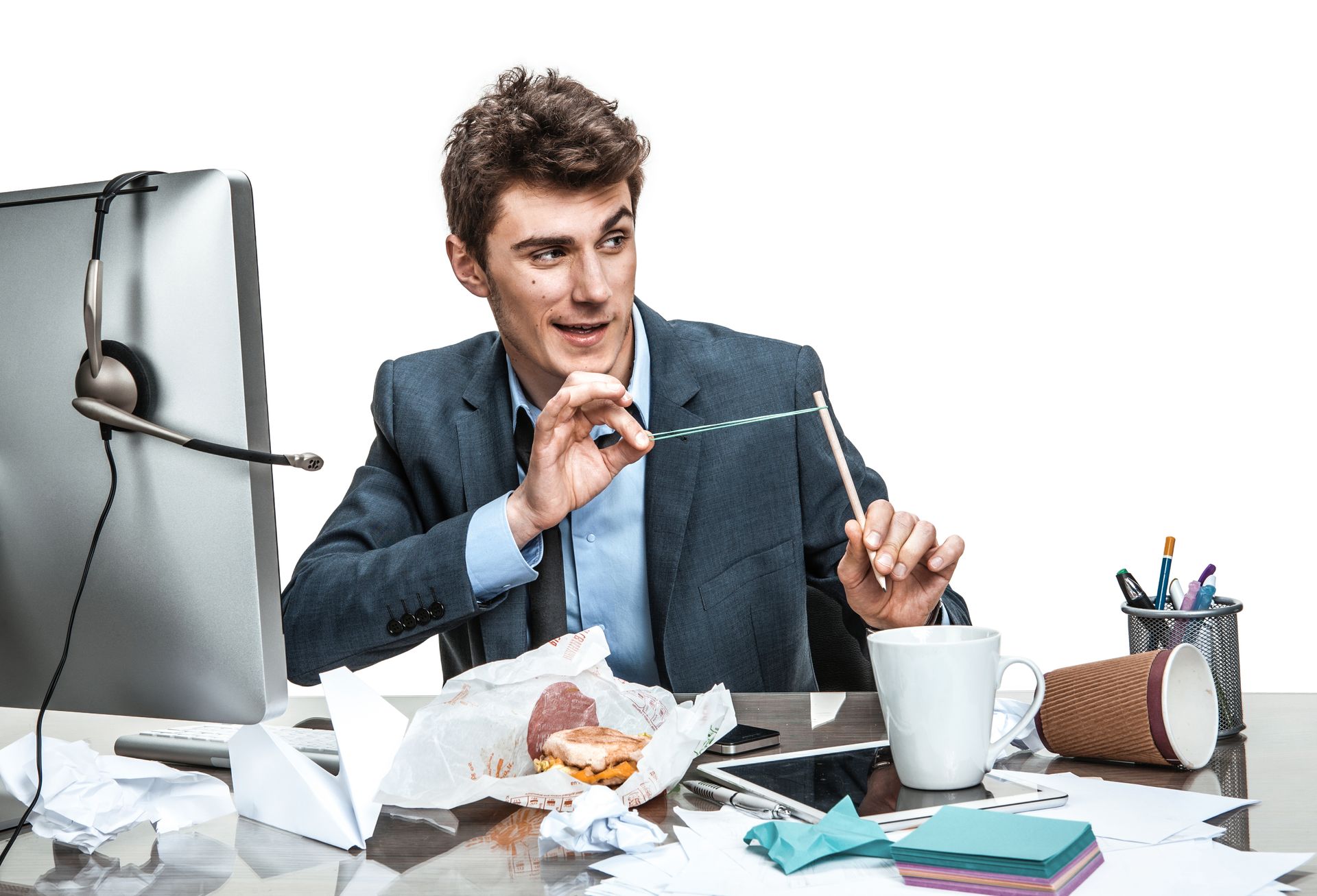 Office worker at messy desk and flicking paper