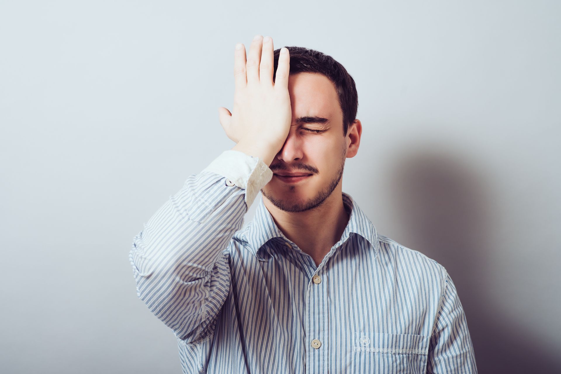 Man hitting self in forehead with a text that says,