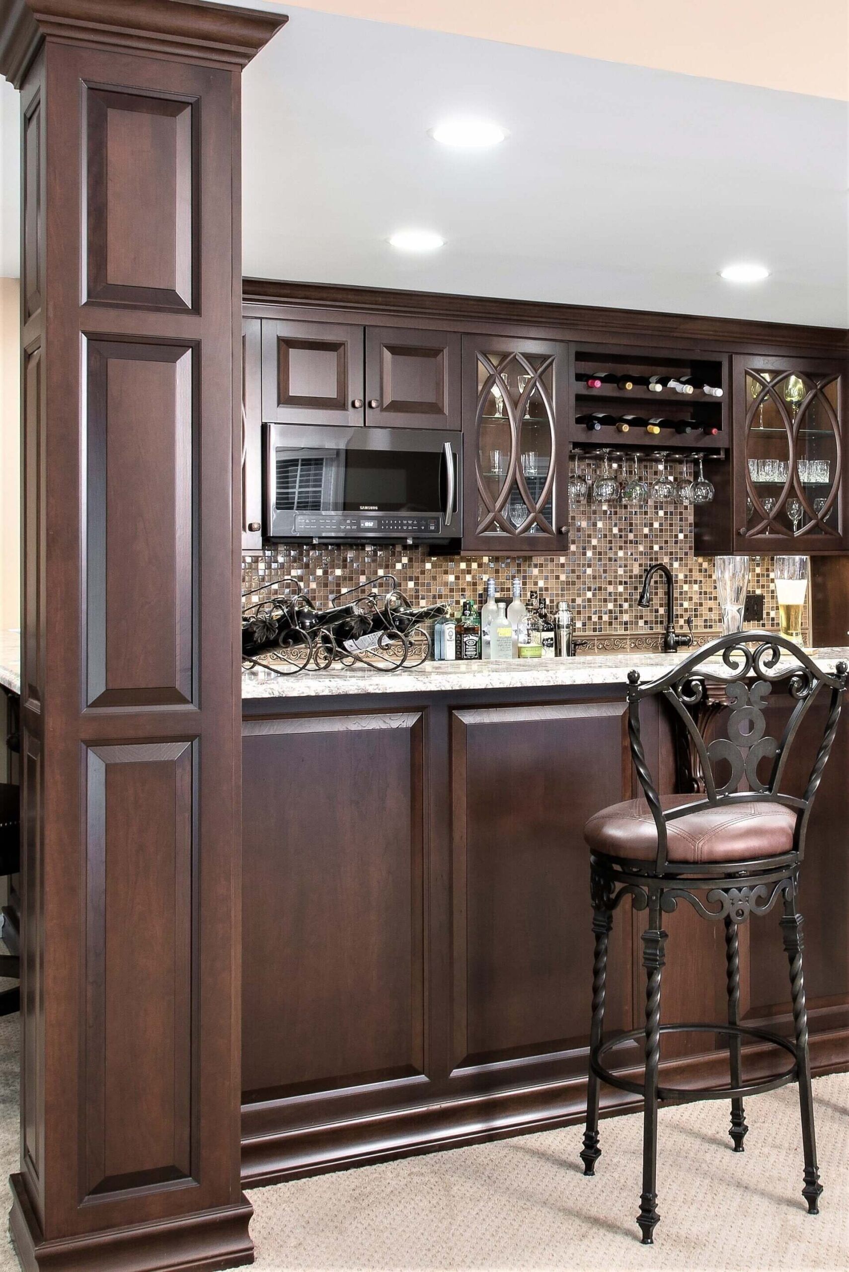 A kitchen with a bar and a chair in it