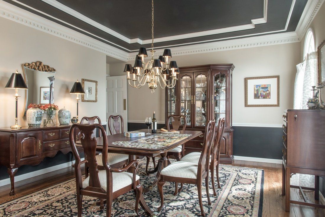 A dining room with a table and chairs and a chandelier