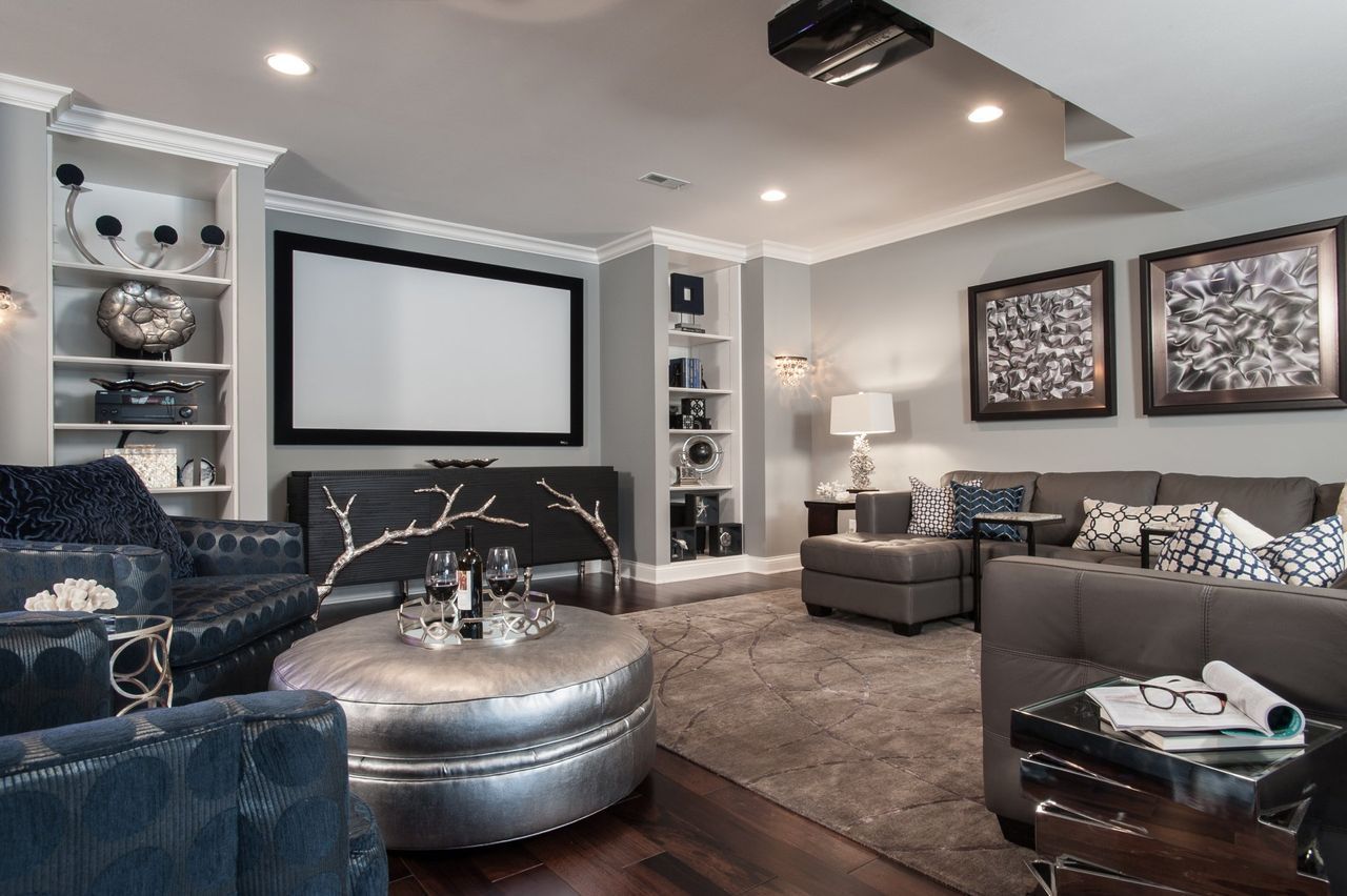 A living room filled with furniture and a projector screen.