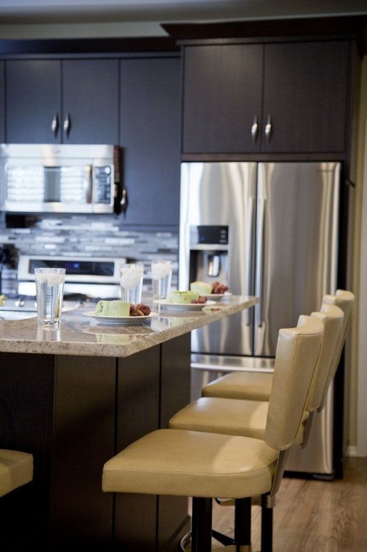 A kitchen with stainless steel appliances and brown cabinets
