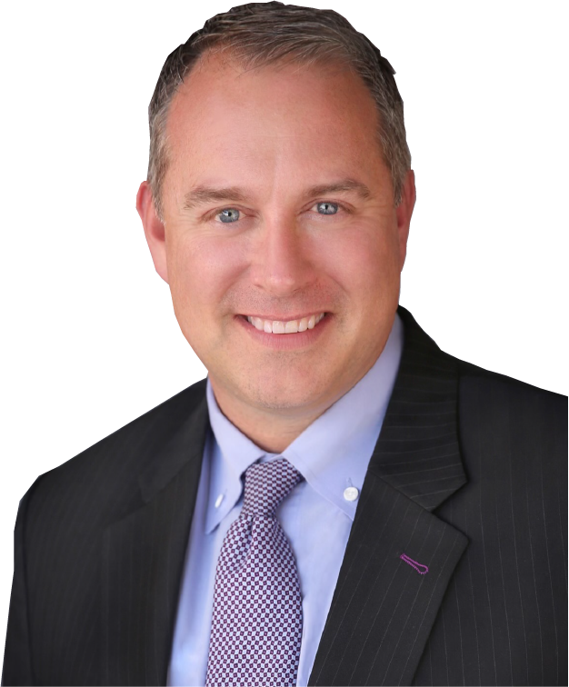 A man in a suit and tie is smiling for the camera
