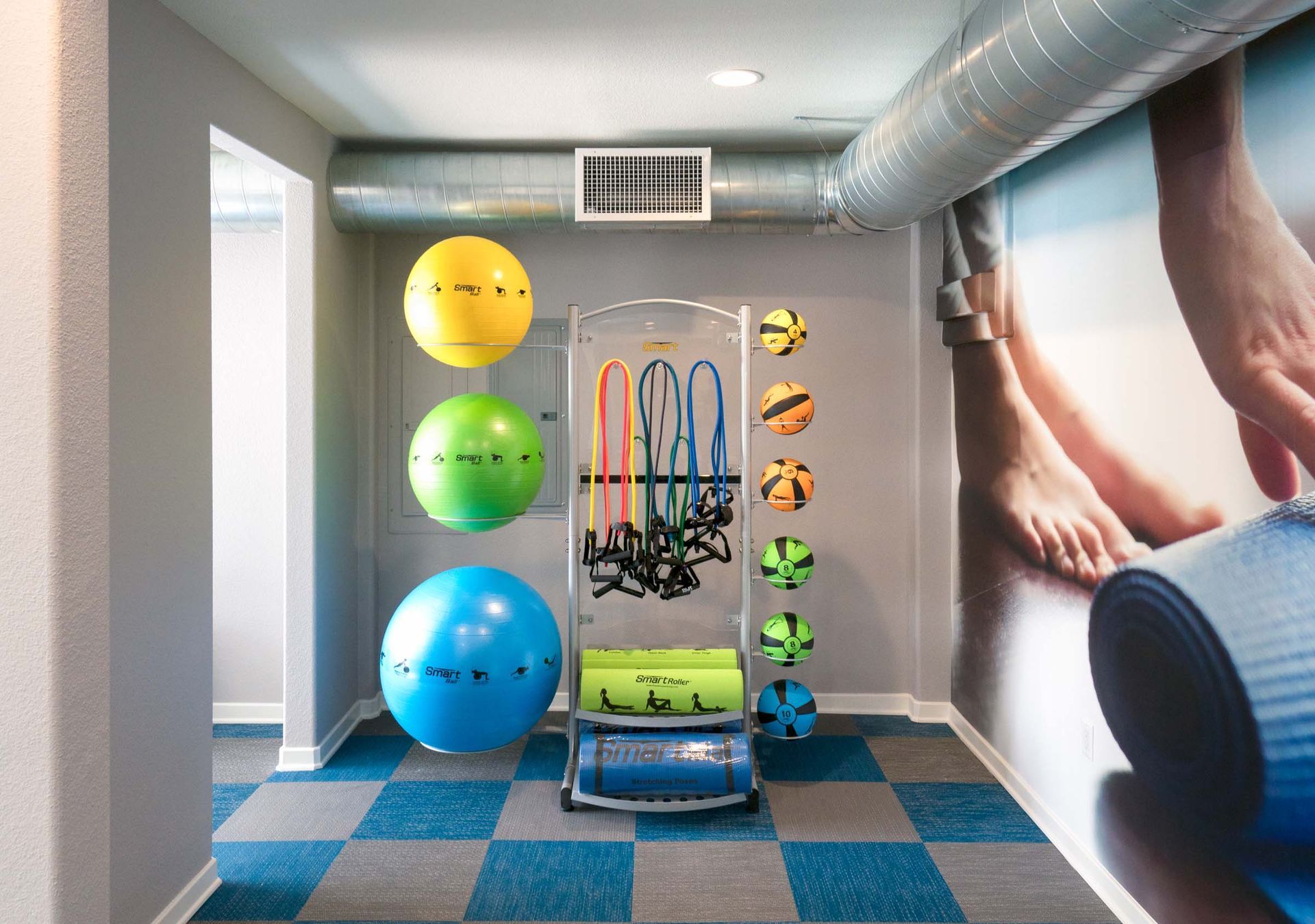 there is a picture of a person 's feet on the wall in the gym .