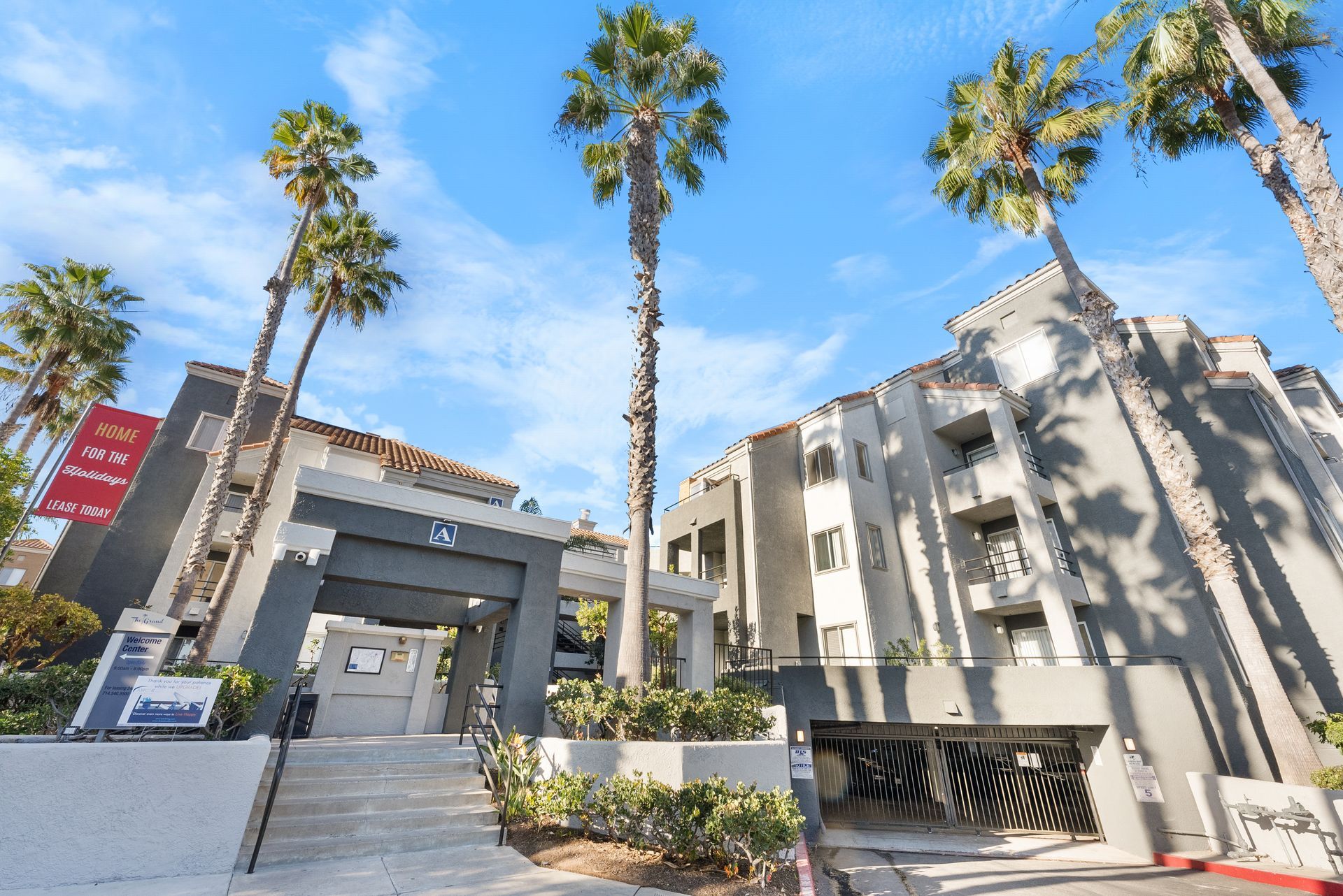 A large apartment building with palm trees in front of it
