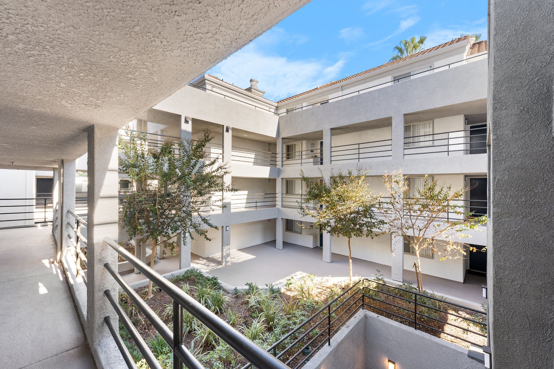 A view of a building from a balcony with a railing