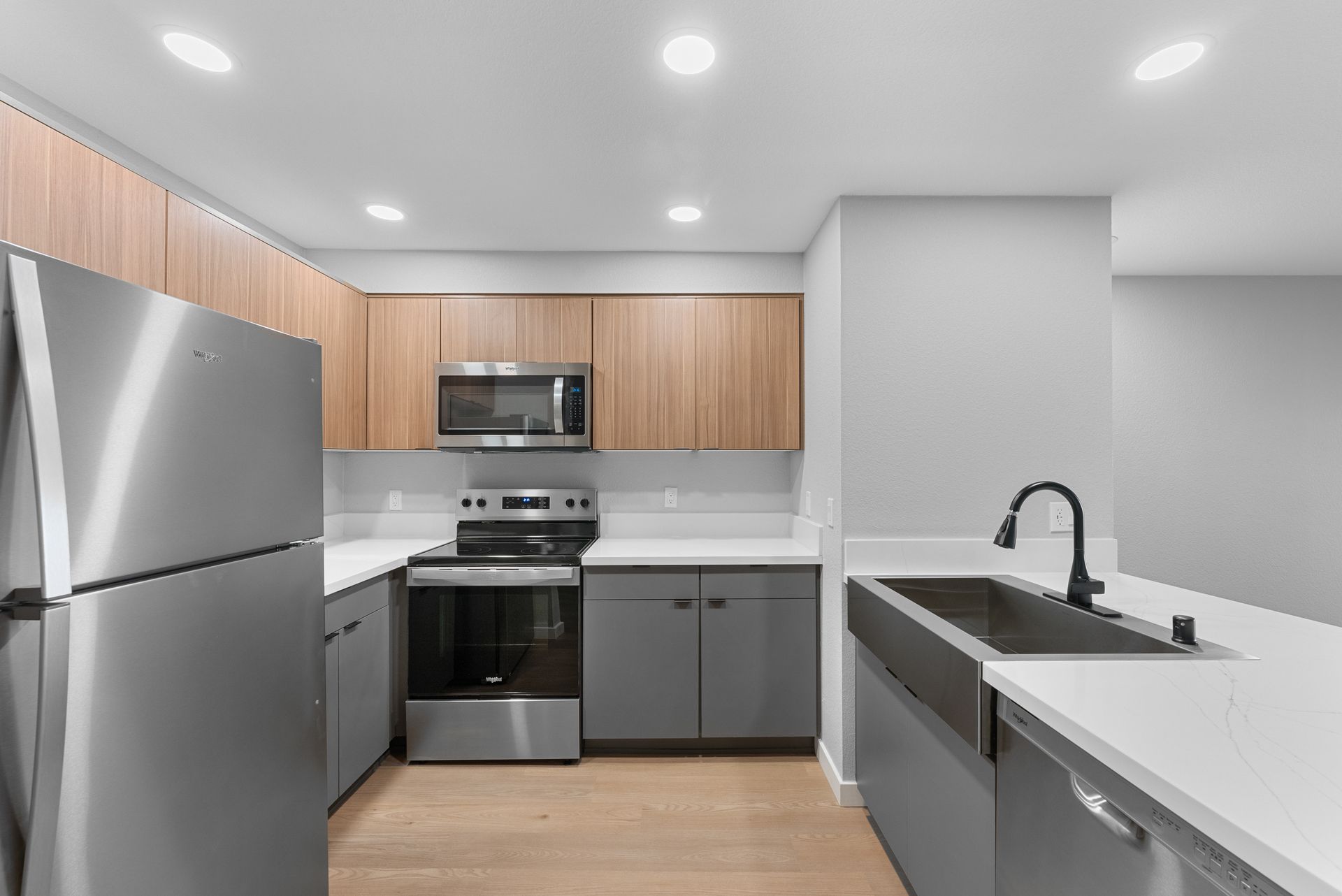 A kitchen with stainless steel appliances and wooden cabinets