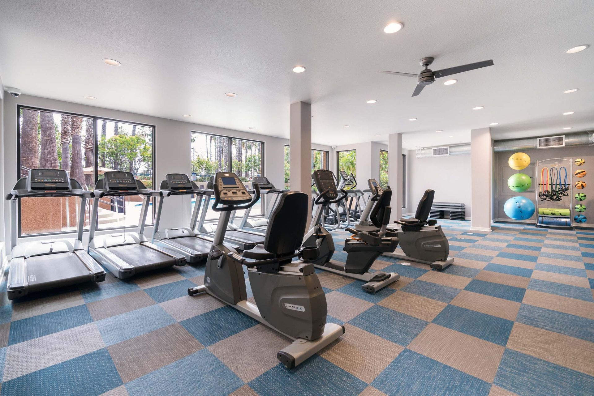 a large gym with a lot of treadmills and exercise bikes .