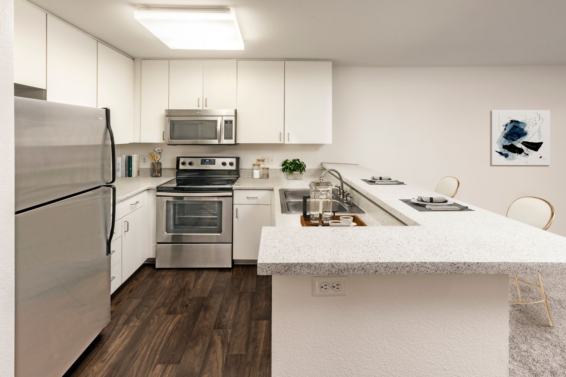 a kitchen with stainless steel appliances and white cabinets