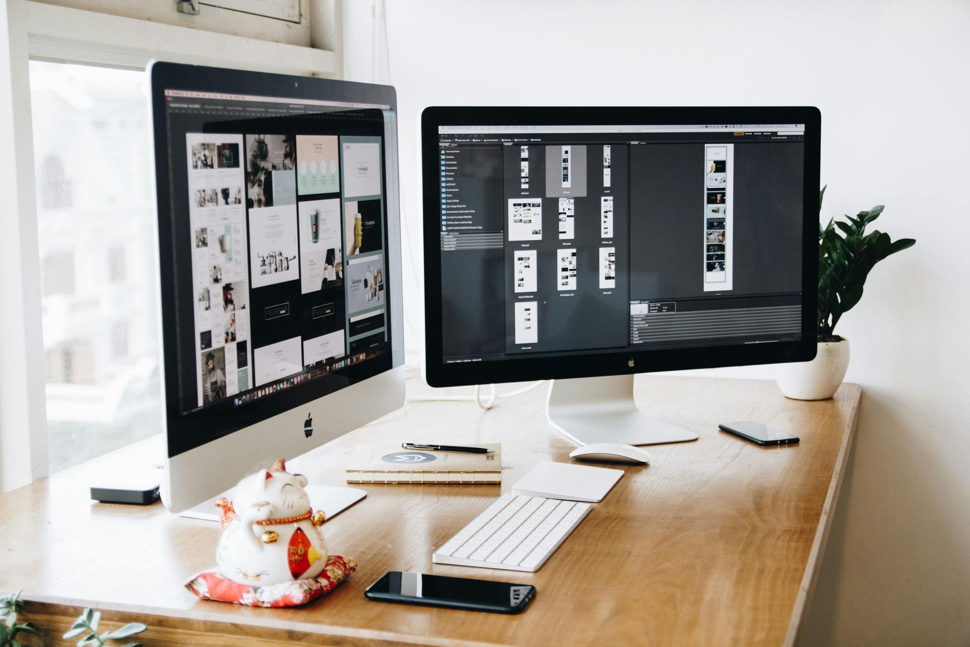 Two computer monitors are sitting on a wooden desk.