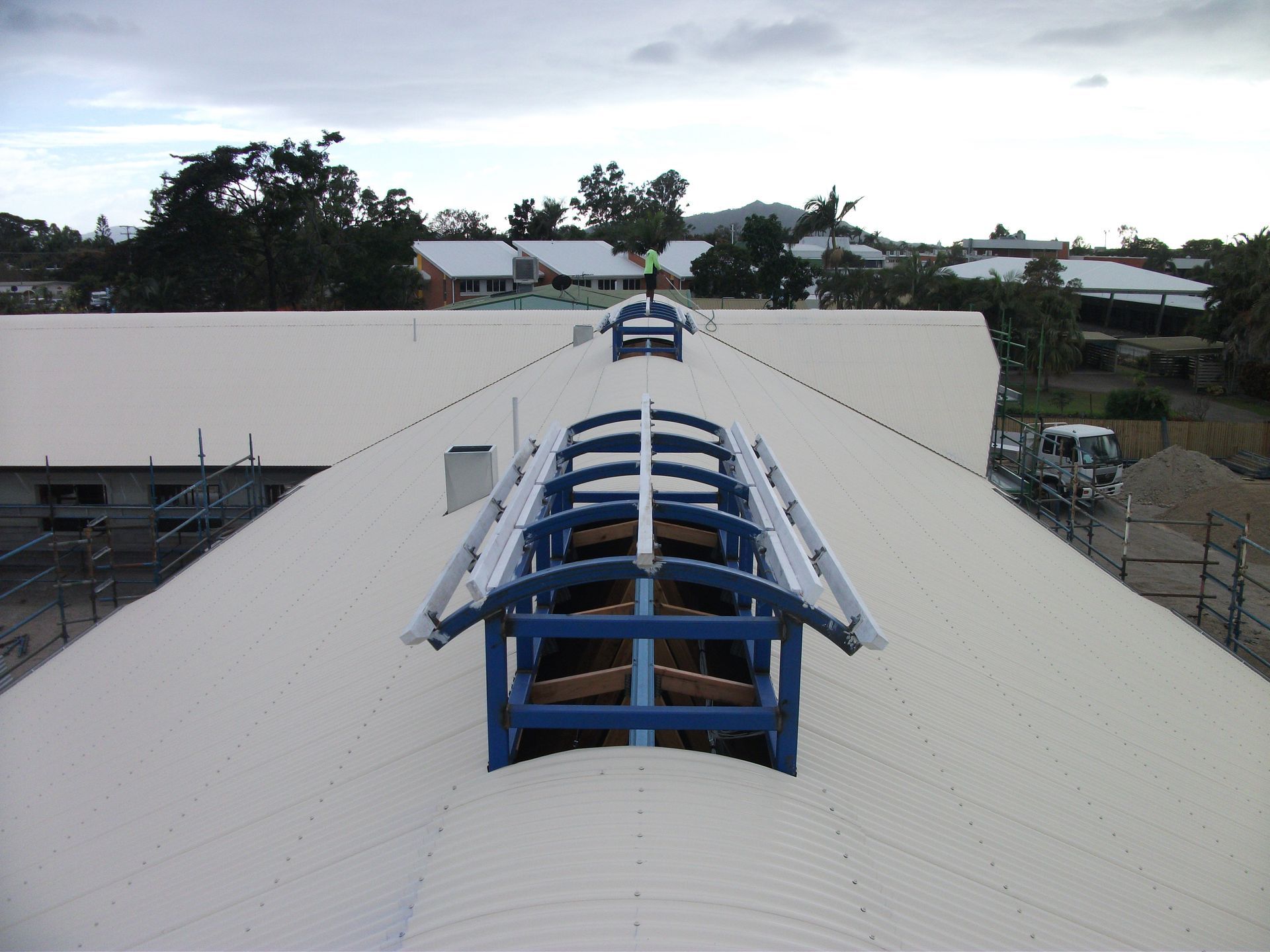 Construction Workers on a Roof With Scaffolding Under a Bright Blue Sky — Roof 4 U in Alice River, QLD