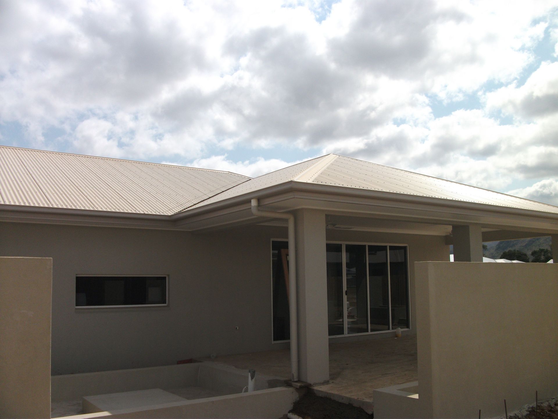 Blue and Gray Building With Mural of Green Tent; Outdoors on Grass — Roof 4 U in Mount Low, QLD