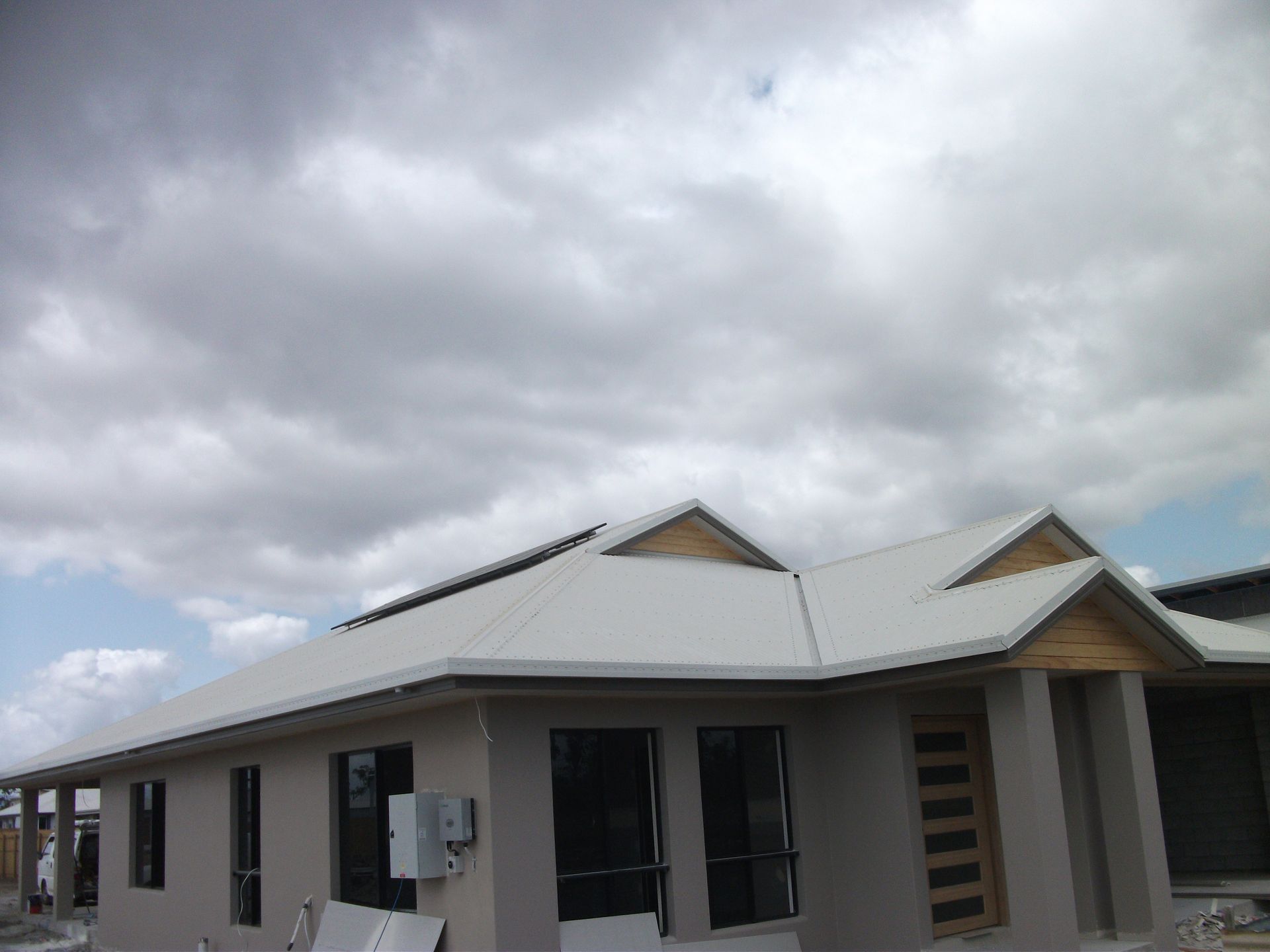 Green Metal Roof With White Ridge, Trees in Background — Roof 4 U in Rasmussen, QLD