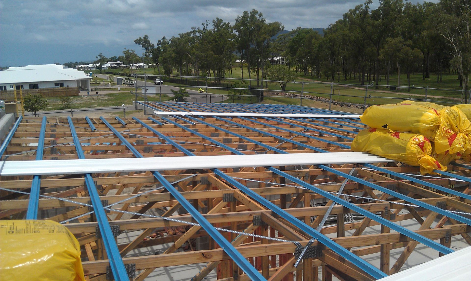 Green Metal Roof With White Ridge, Trees in Background — Roof 4 U in Rasmussen, QLD
