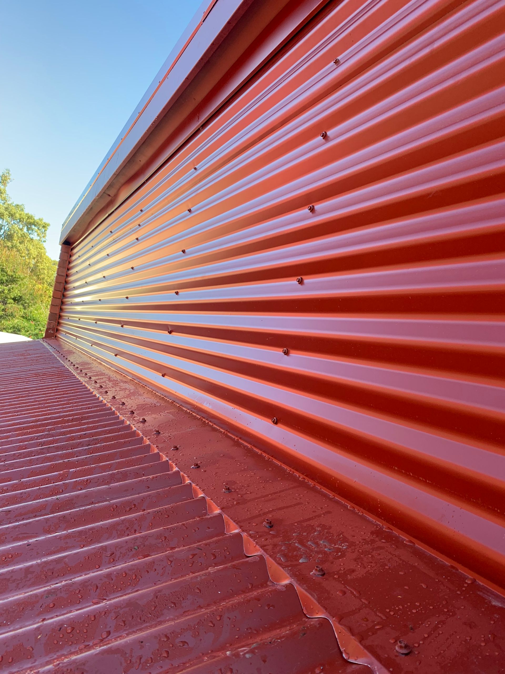 White Corrugated Metal Roof With a Vehicle in the Background — Roof 4 U in Alice River, QLD