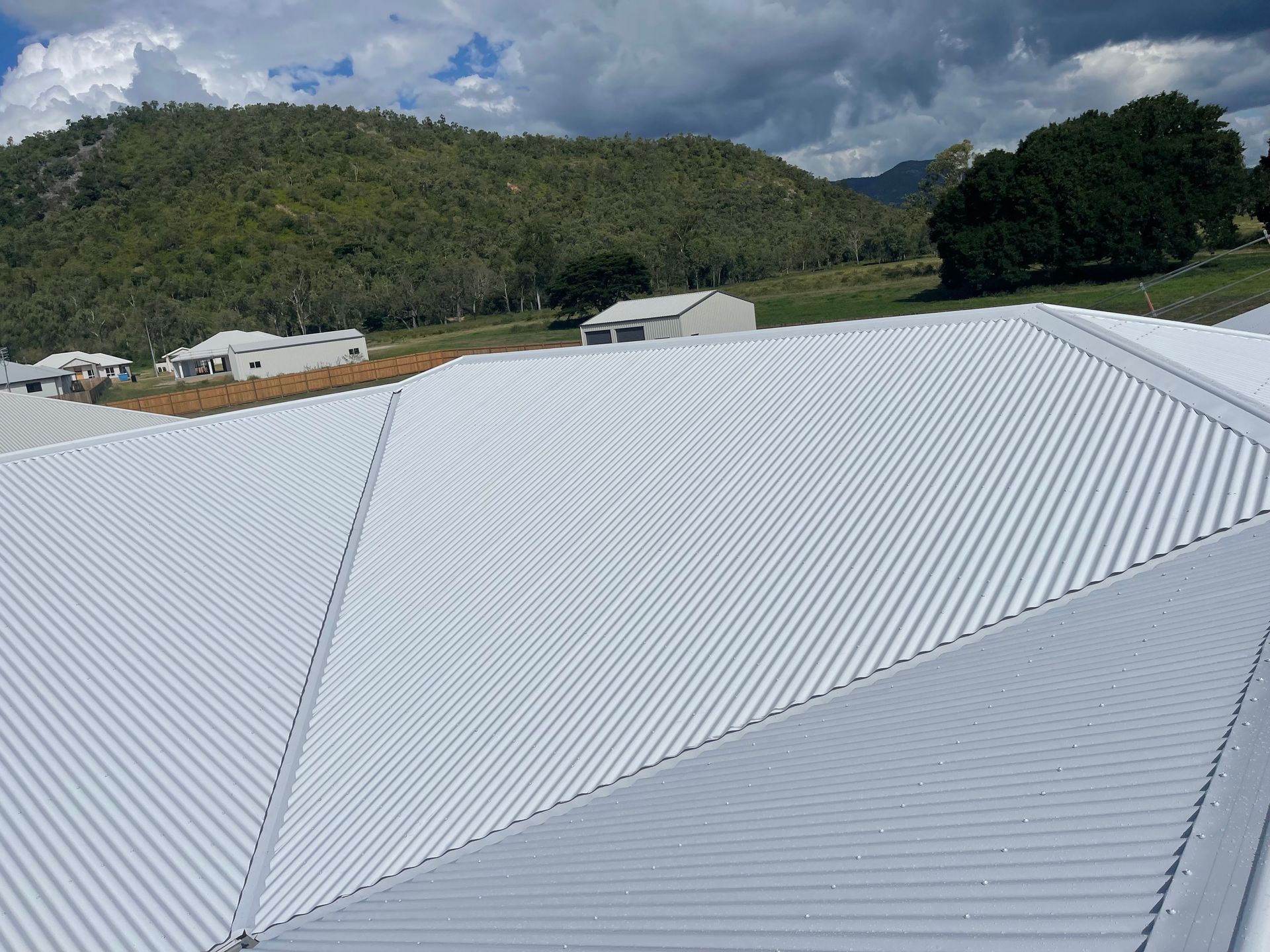 Silver Metal Roof With a Rotating Vent on a Clear, Sunny Day  — Roof 4 U in Mount Low, QLD