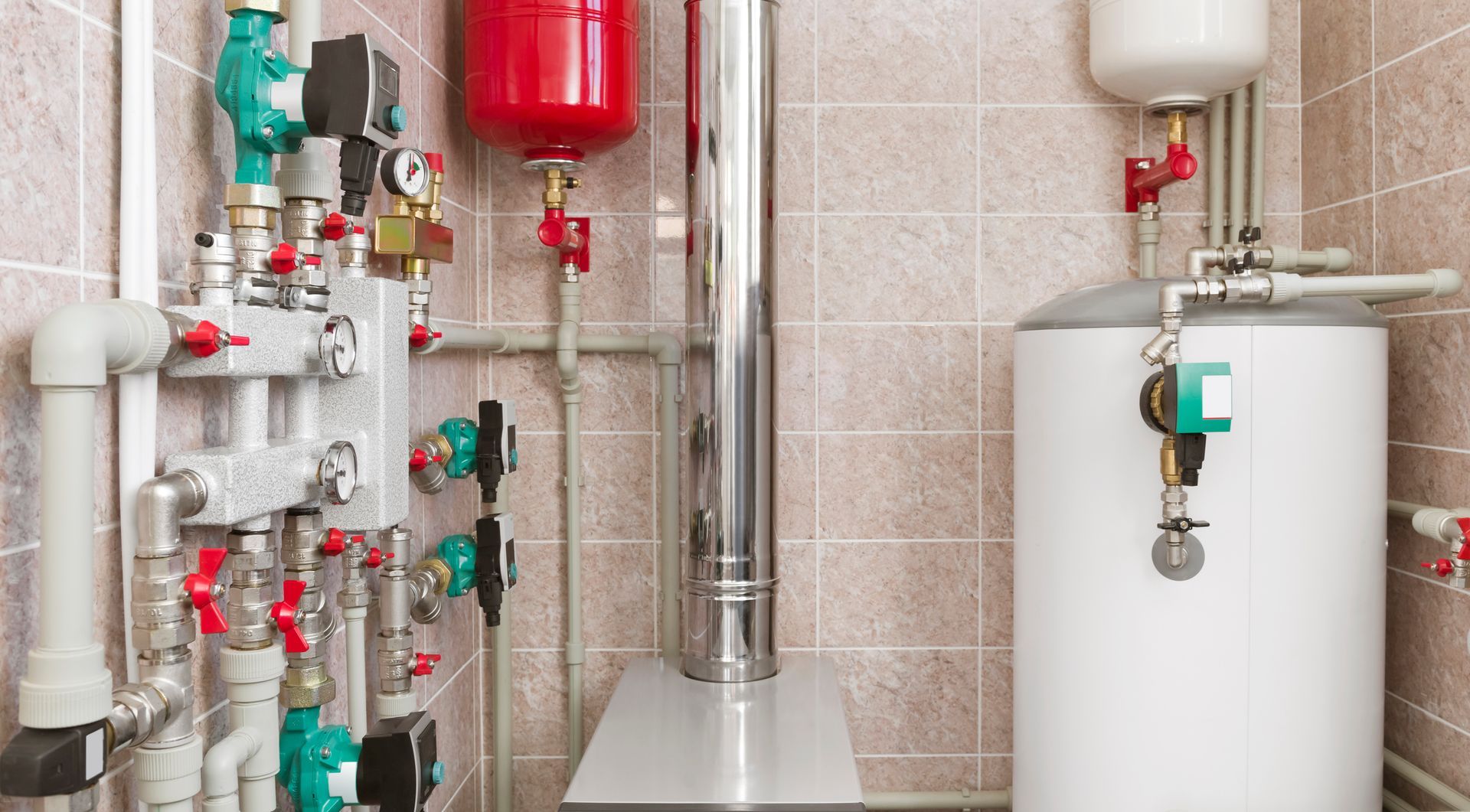 Plumbing and heating system in a tiled utility room with pipes, valves, and water heaters.