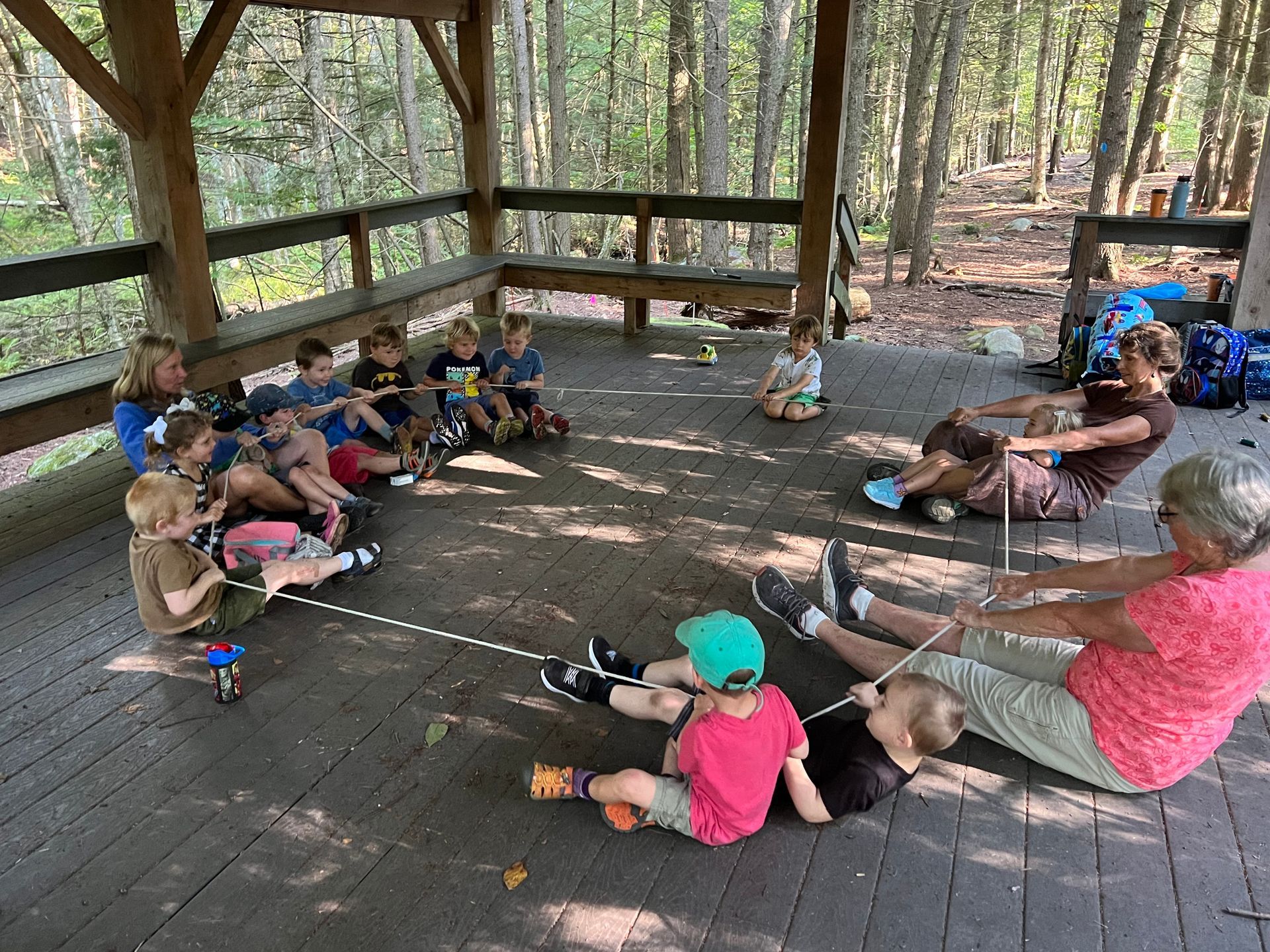 Preschoolers outside using a rope game