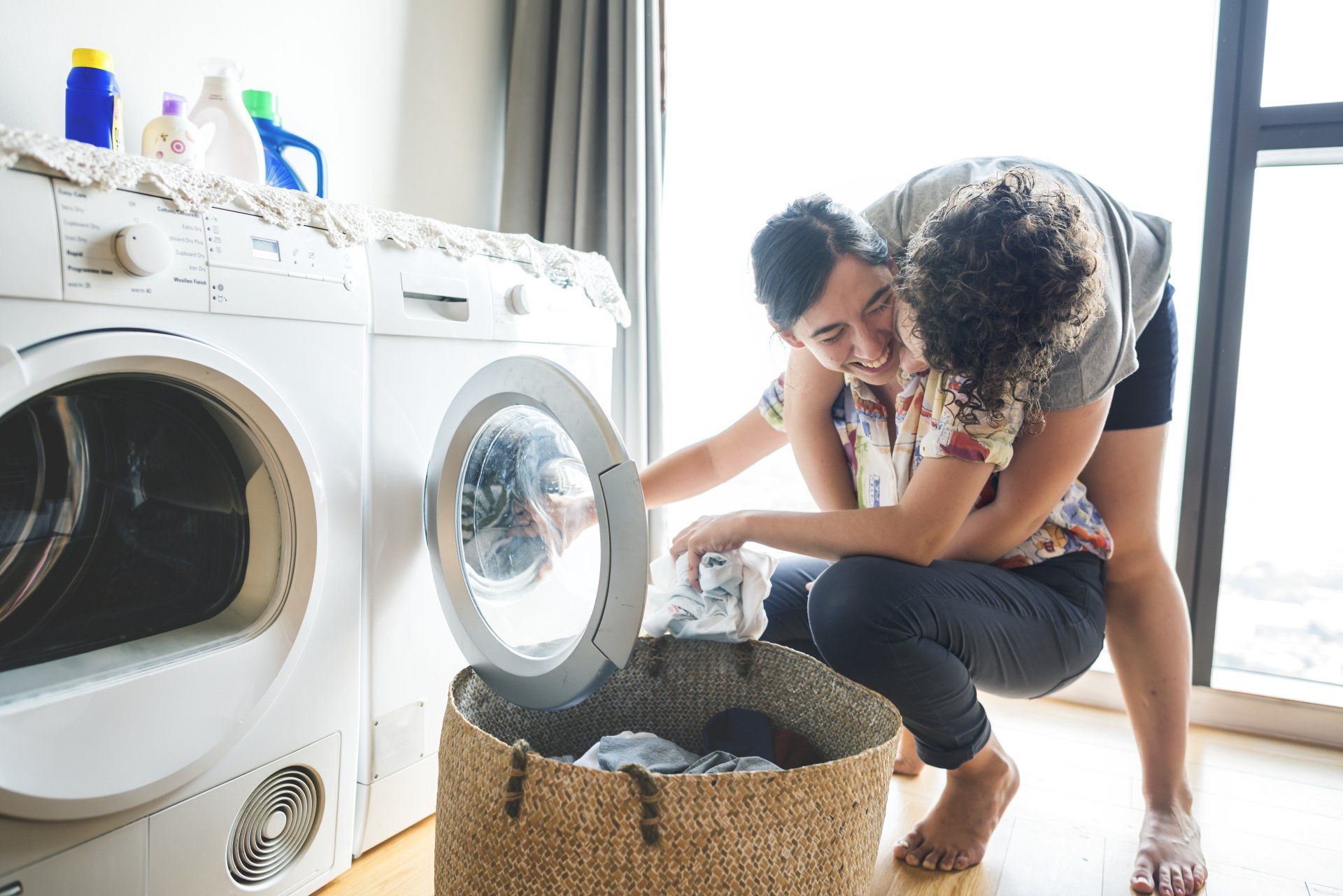 Couple hugging while getting laundry