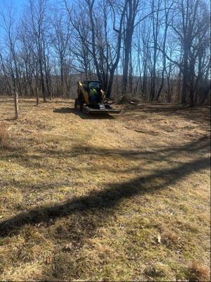 A person holding a baby up in the air indoors near a window, baby smiling.