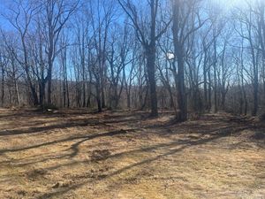 Family gathered at a dining table in a kitchen. They are eating and talking together.